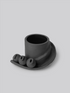 Black matte stoneware ceramic mug with a slide moving down the side of the mug as a handle and three detachable ornamental balls.