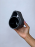 Black matte stoneware ceramic mug with a wide wrap around handle.