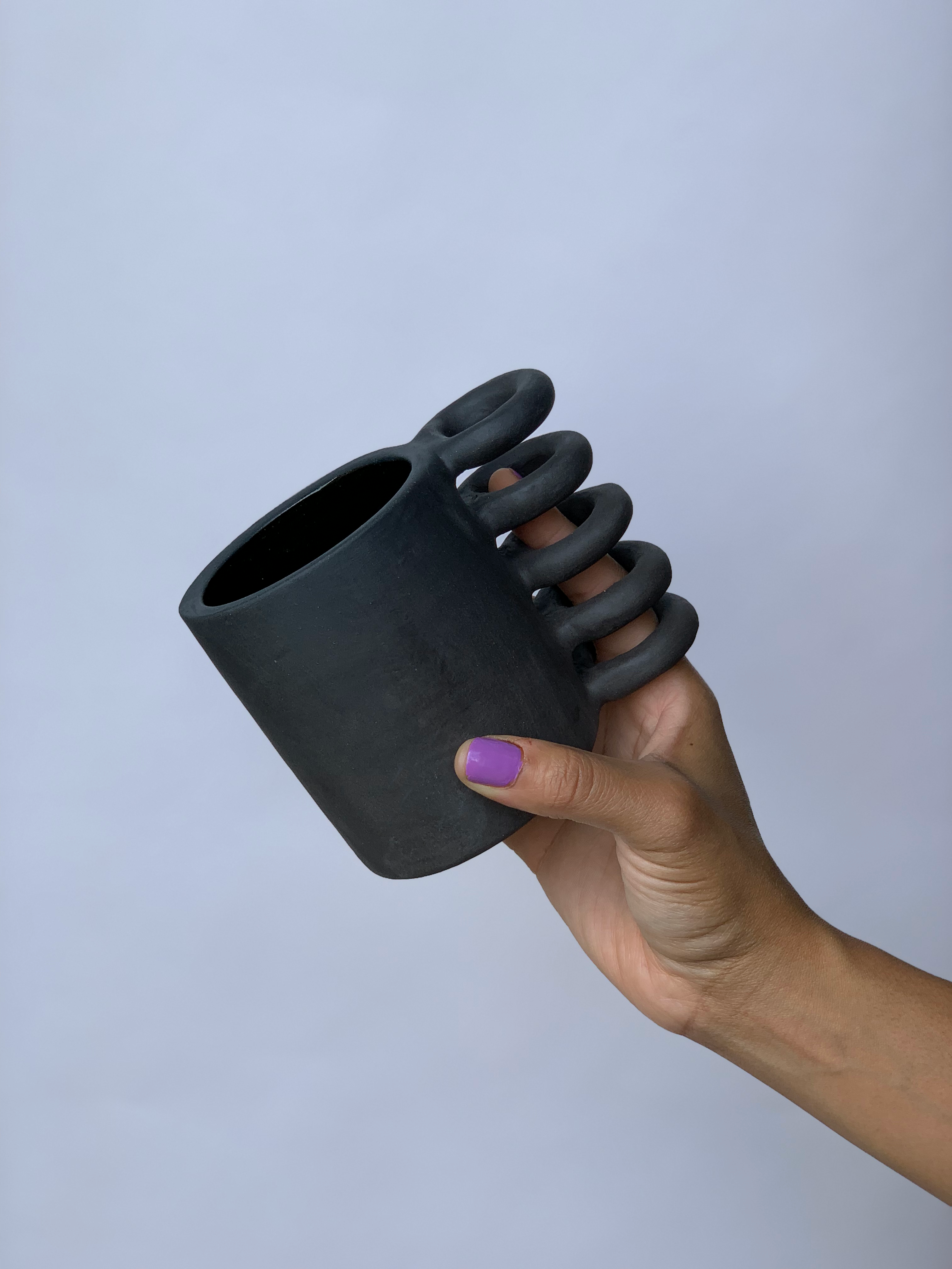 Black matte stoneware ceramic mug with a full spiral handle.