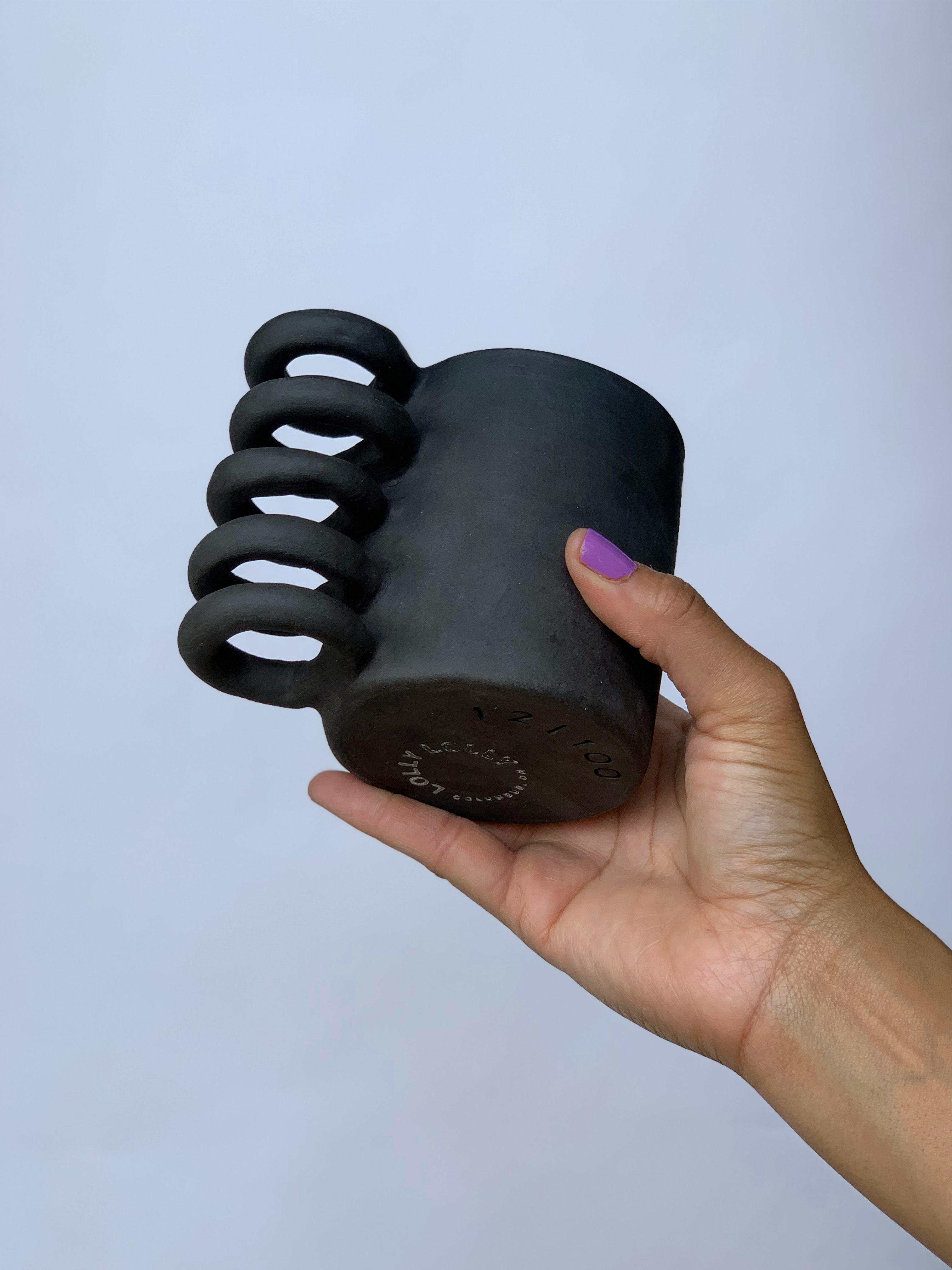 Black matte stoneware ceramic mug with a full spiral handle.