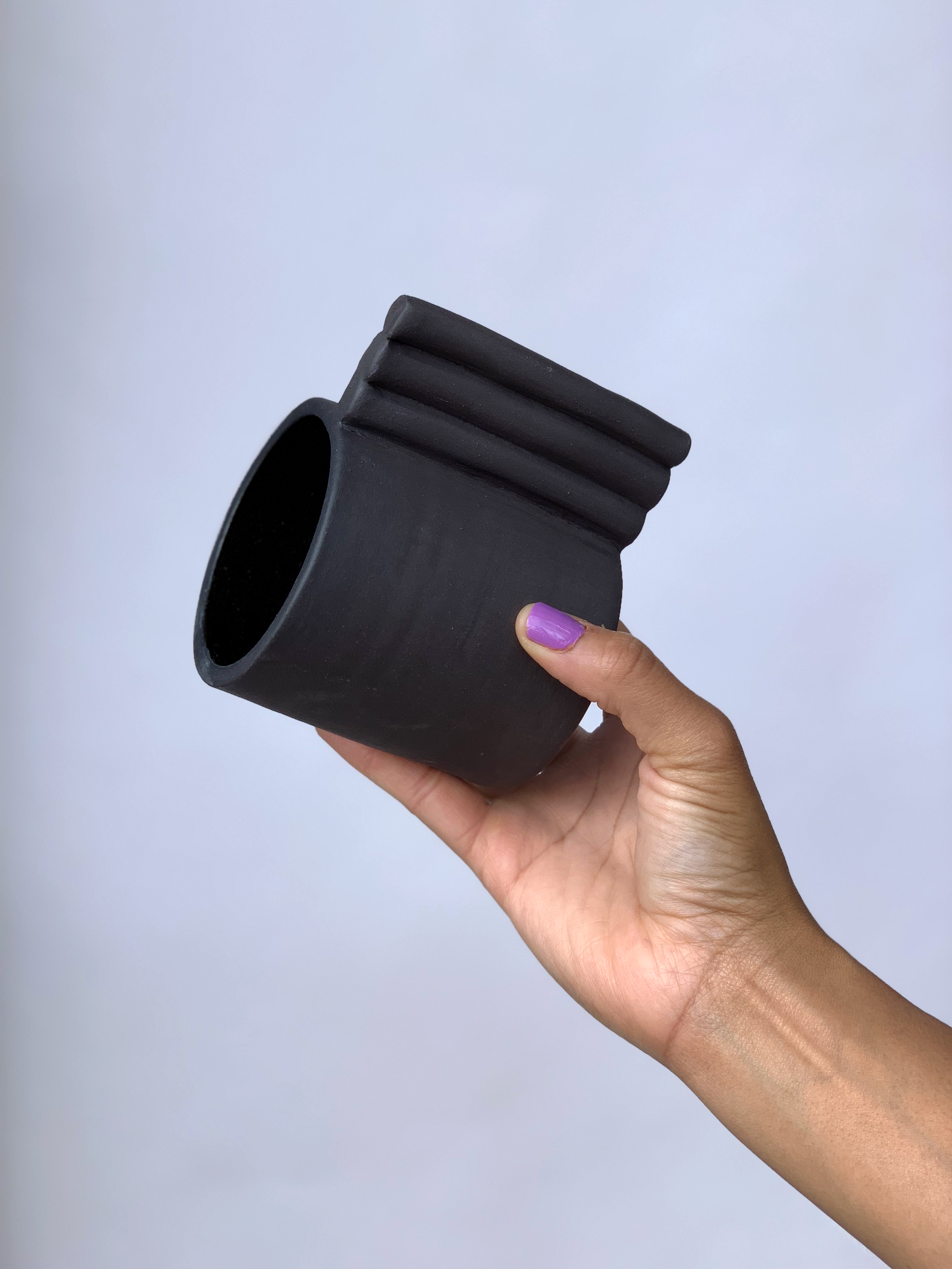 Black matte stoneware ceramic mug with extended side by side bars handle.