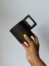 Black matte stoneware ceramic mug with a  rectangle handle.