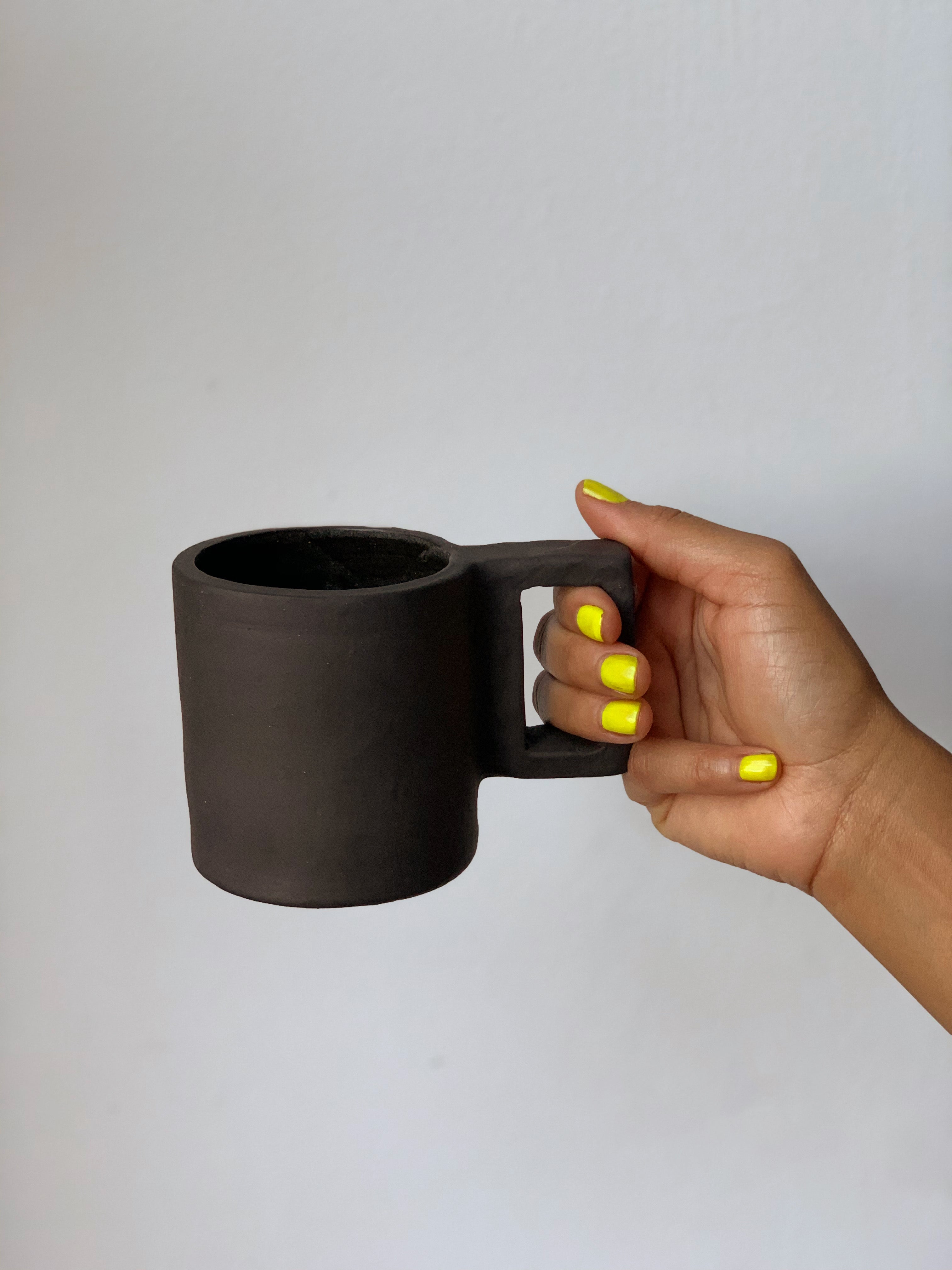 Black matte stoneware ceramic mug with a rectangle handle.