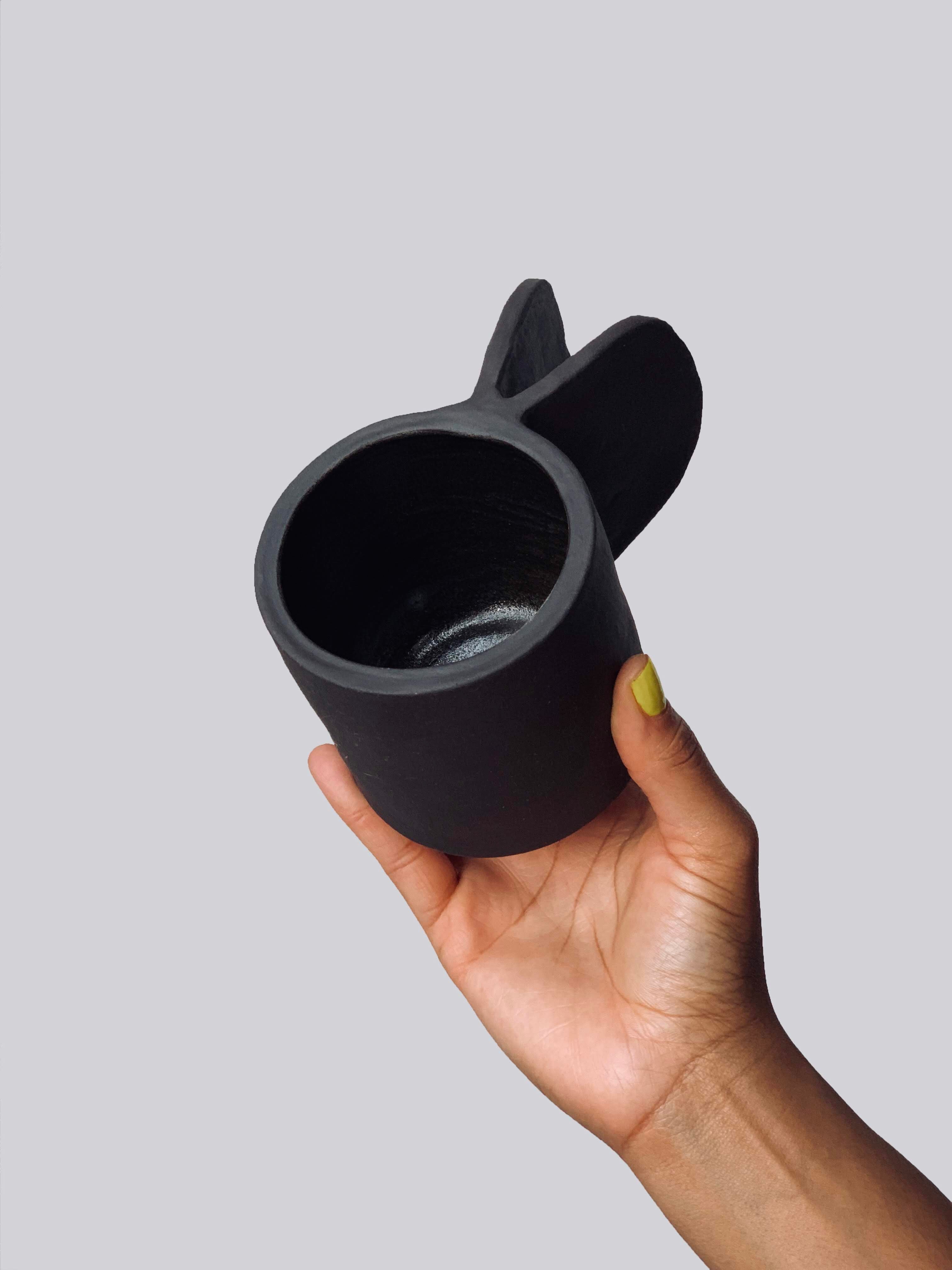 Black matte stoneware ceramic mug with extended clip handle.