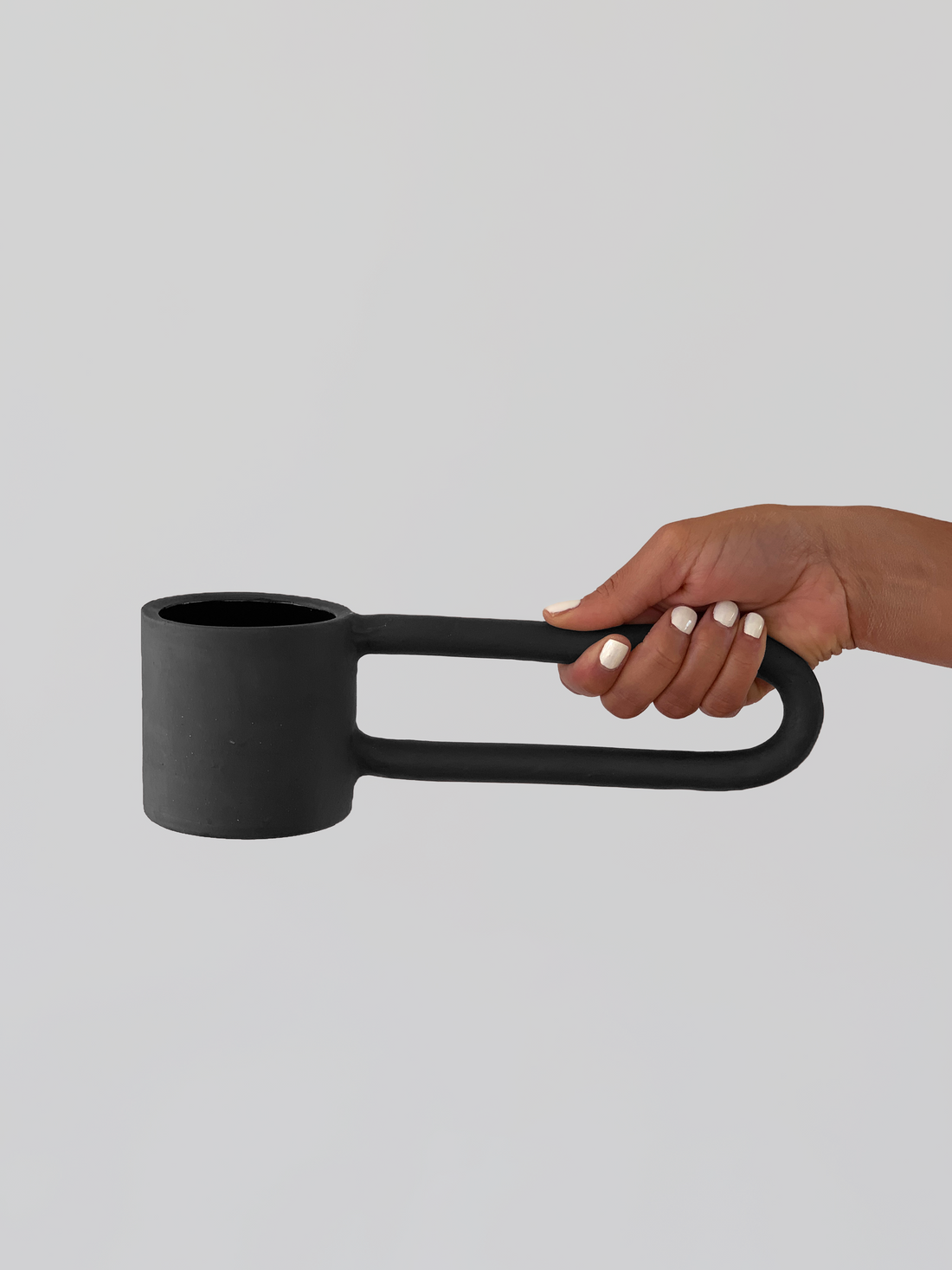 Black matte stoneware ceramic mug with a n extra long half circle handle.