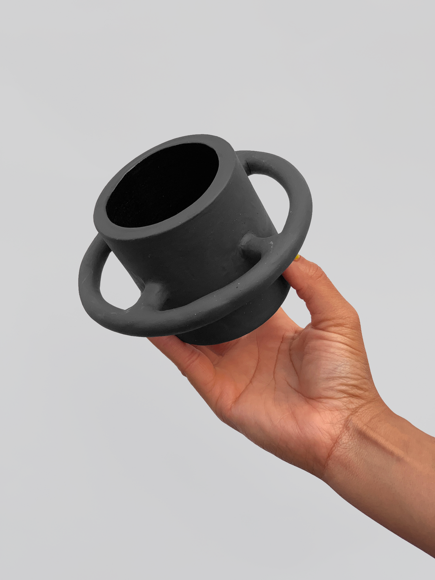 Black matte stoneware ceramic mug with full wrap around circle handle.