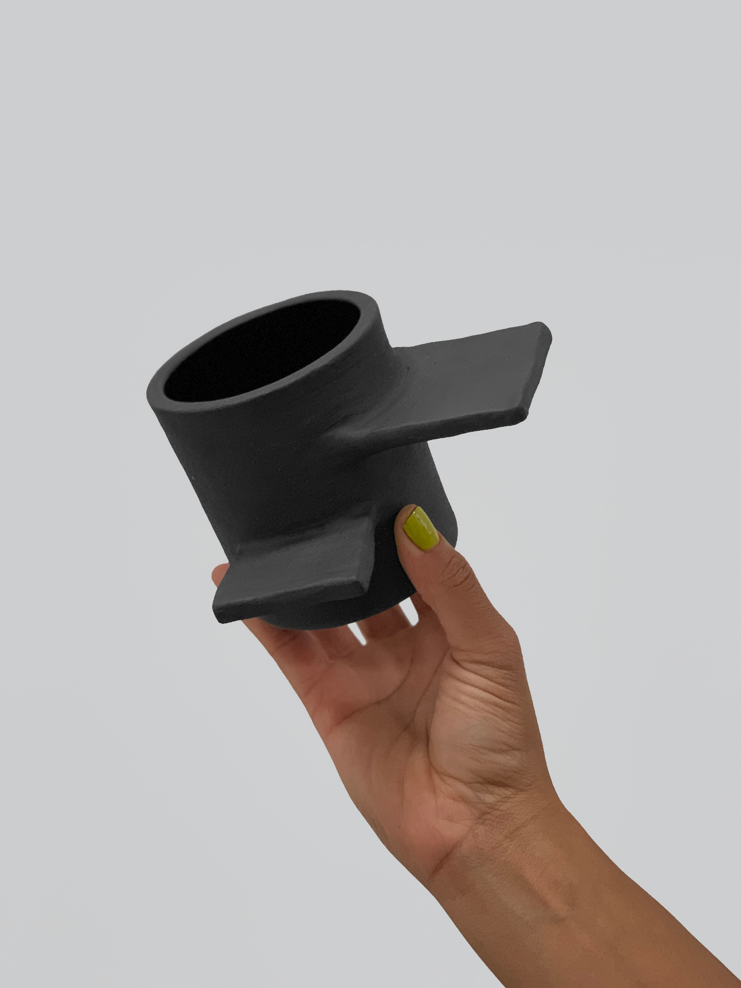 Black matte stoneware ceramic mug with spiral stairs handle.