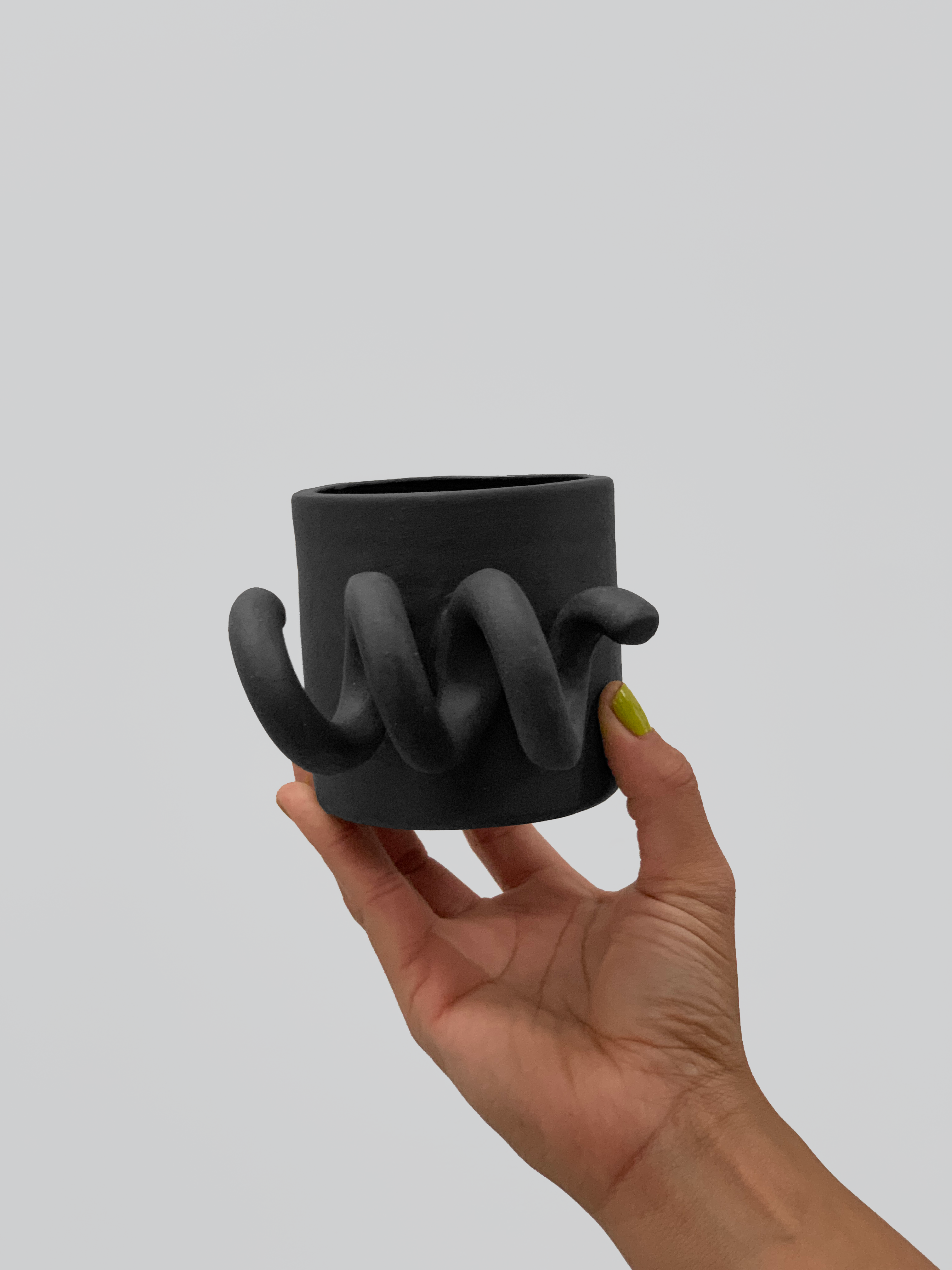 Black matte stoneware ceramic mug with a thick side spiral handle.