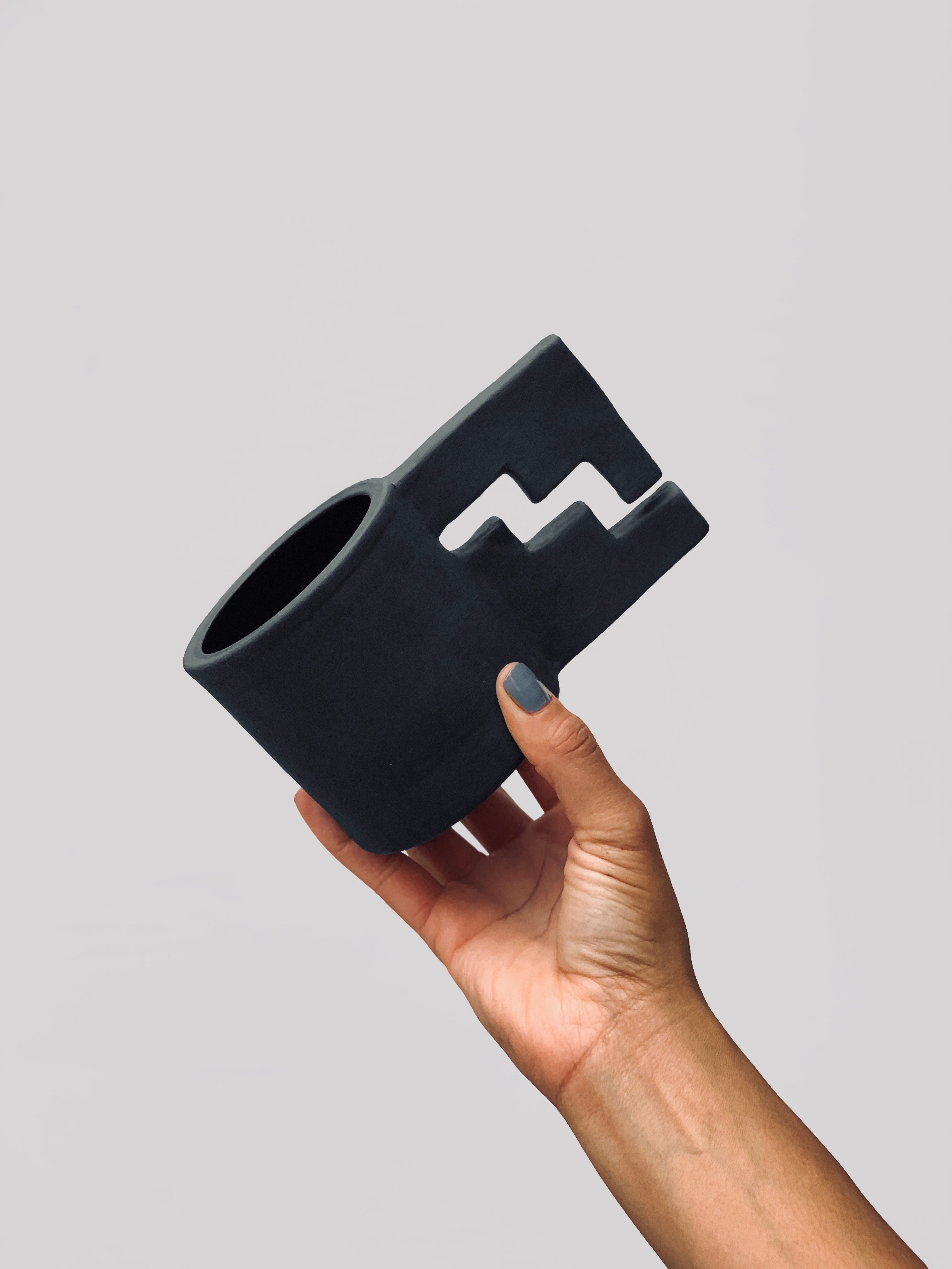 Black matte stoneware ceramic mug with an enclosed thunderbolt handle.