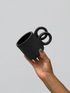 Black matte stoneware ceramic mug with side staggered full circle handles.