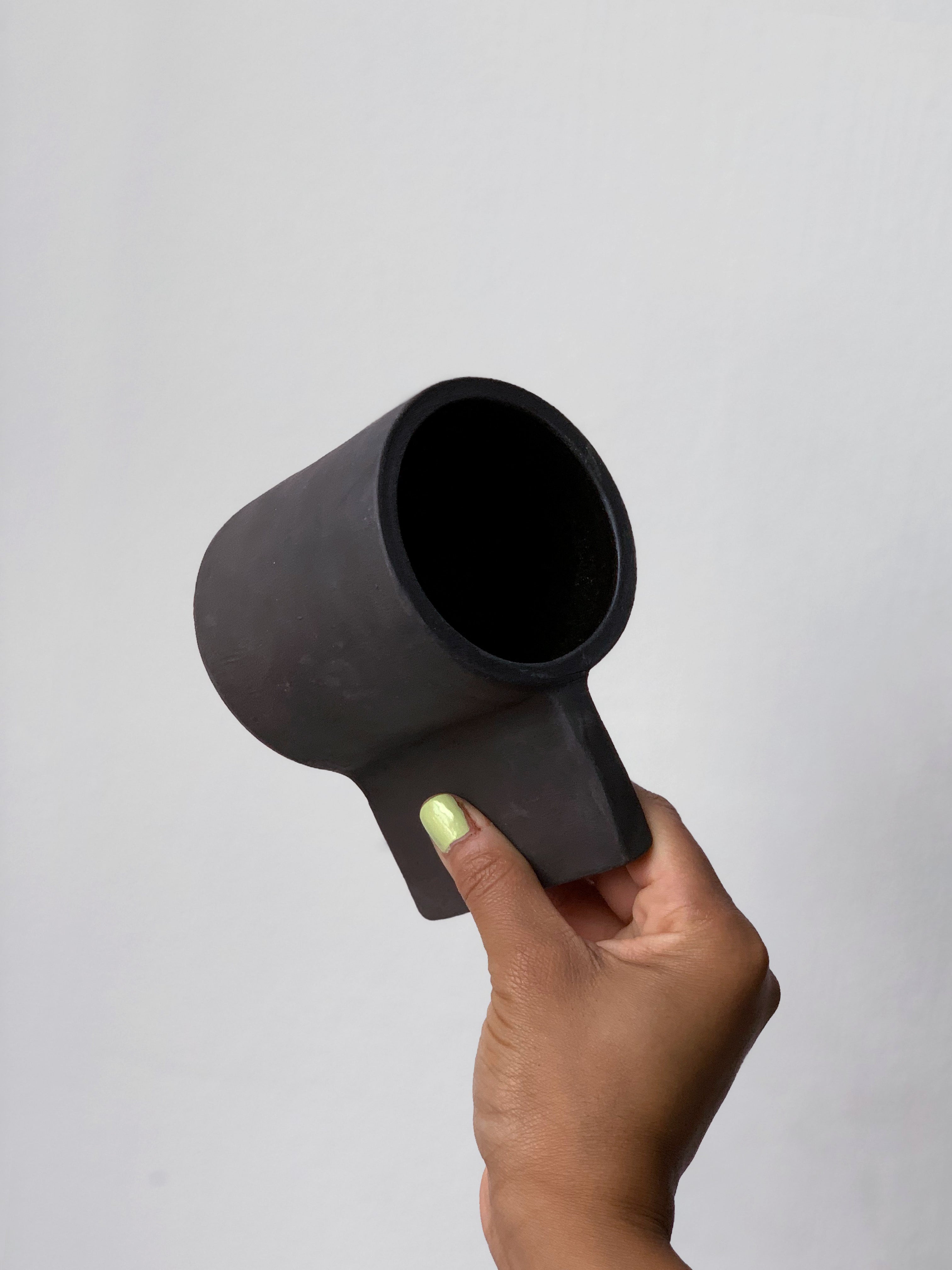 Black matte stoneware ceramic mug with a long flat wide handle.