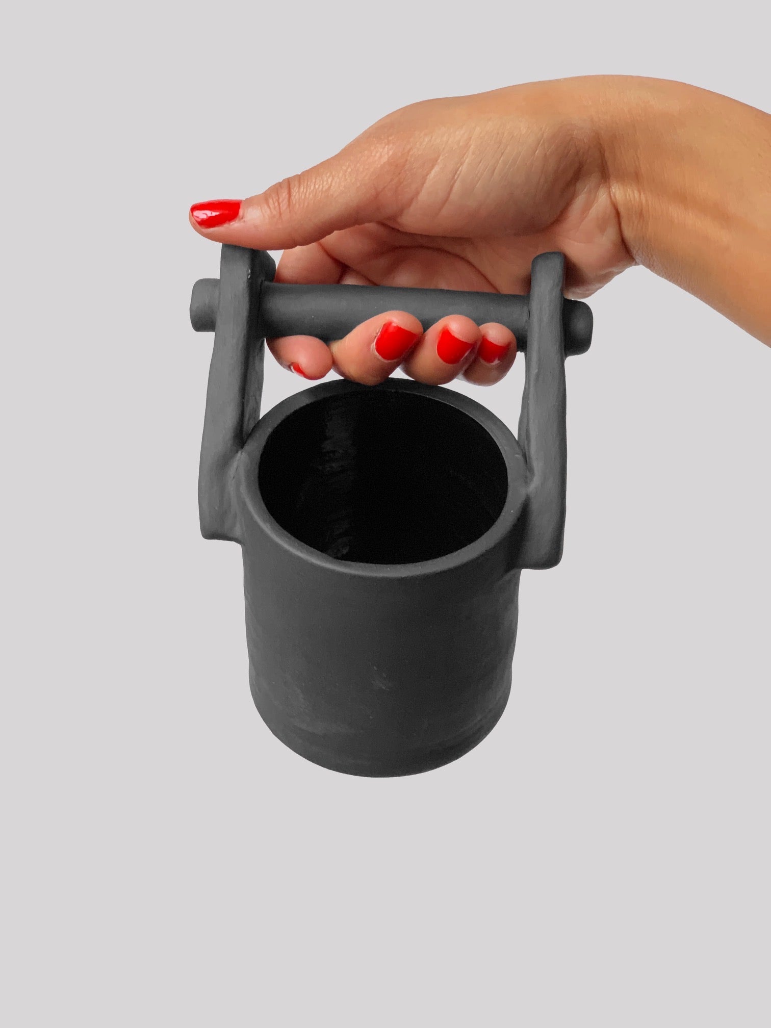 Black matte stoneware ceramic mug with upwards facing bar holder handle.