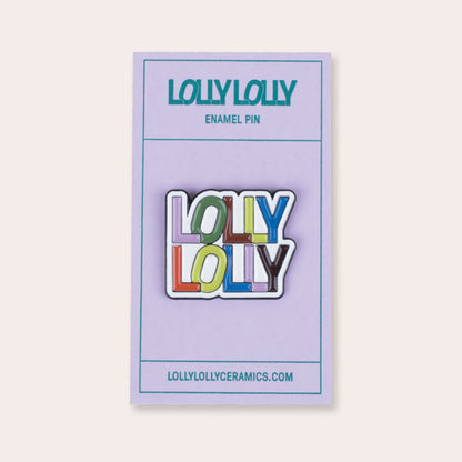 A soft enamel pin that reads &quot;Lolly Lolly Ceramics&quot; in a stacked formation with PVC rubber back. 