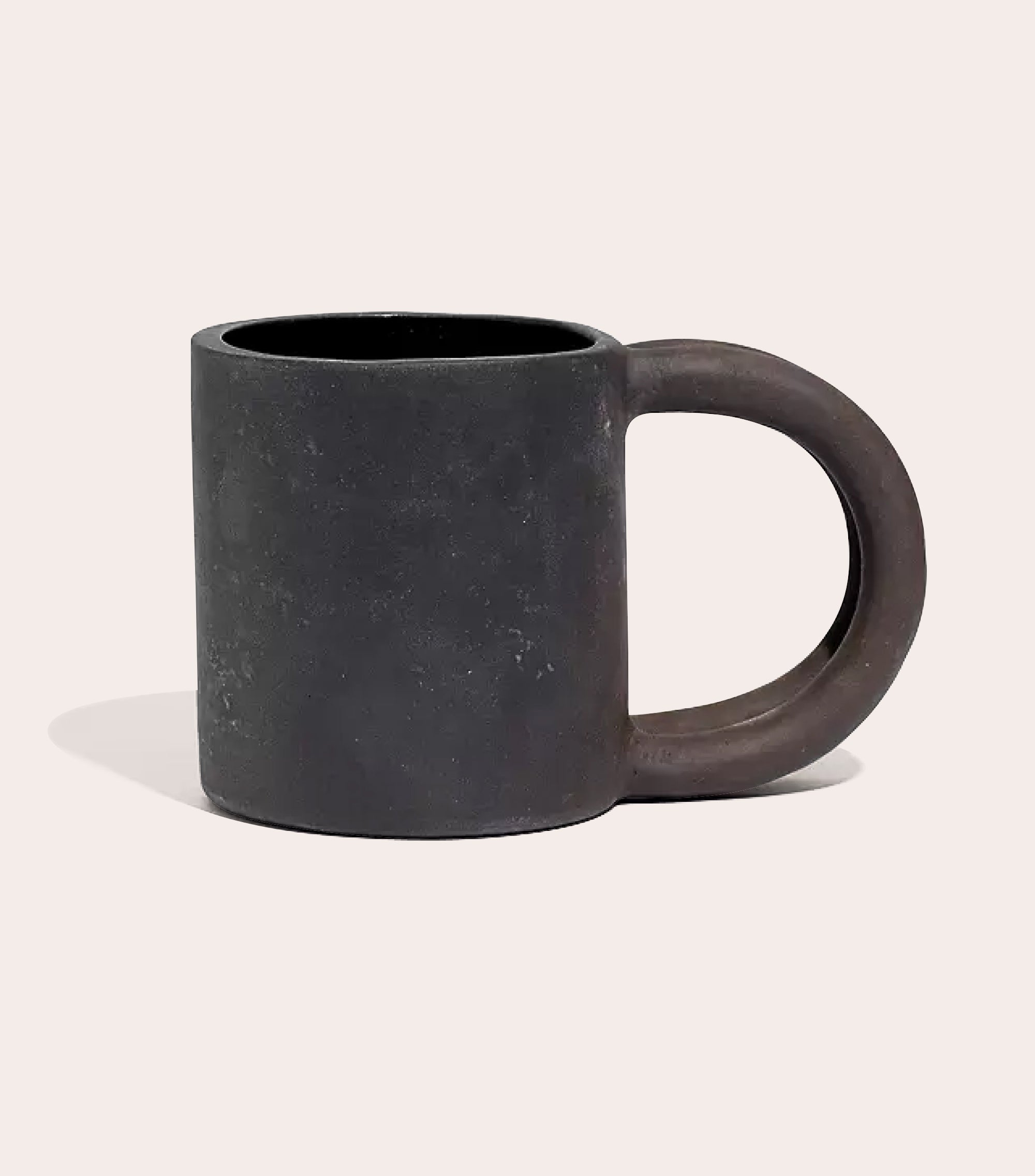 Black matte stoneware ceramic mug with two circle handles.