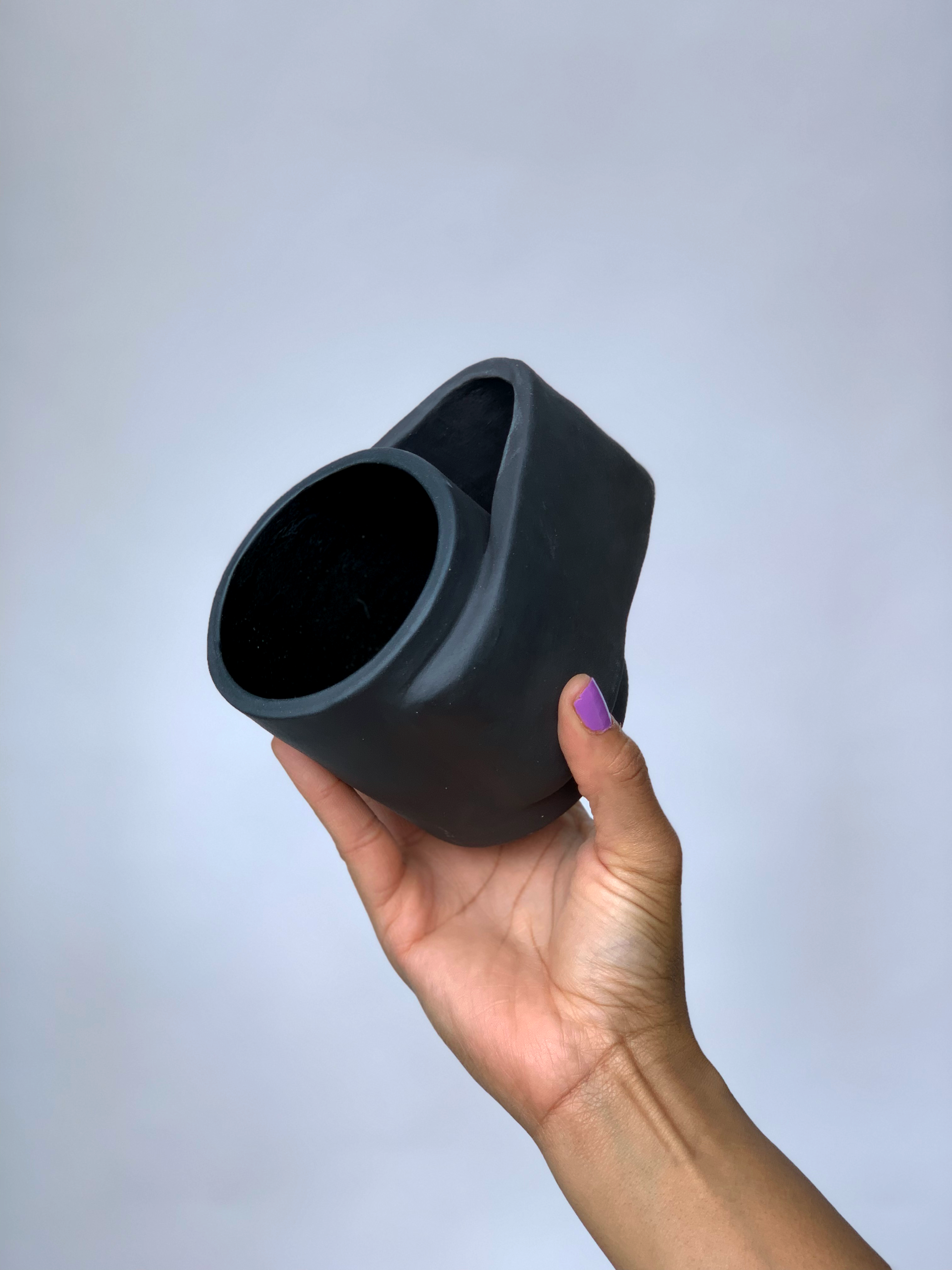Black matte stoneware ceramic mug with a wide wrap around handle.