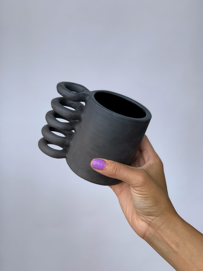 Black matte stoneware ceramic mug with a full spiral handle.