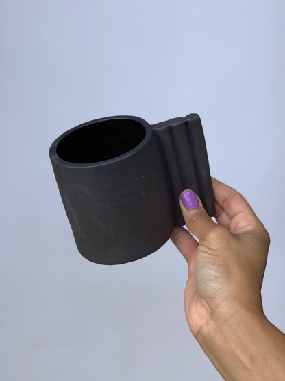 Black matte stoneware ceramic mug with extended side by side bars handle.