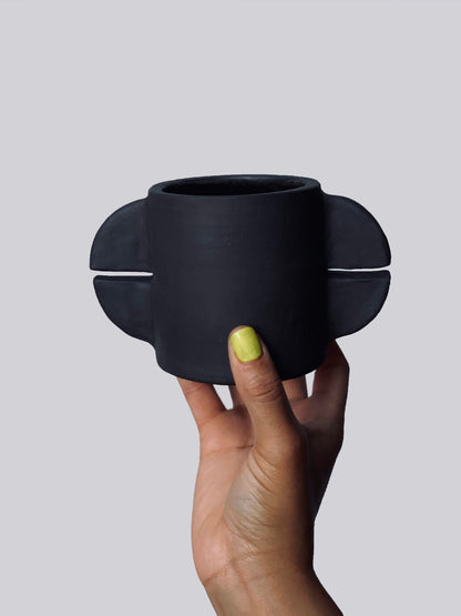 Black matte stoneware ceramic mug with double split circle handles.