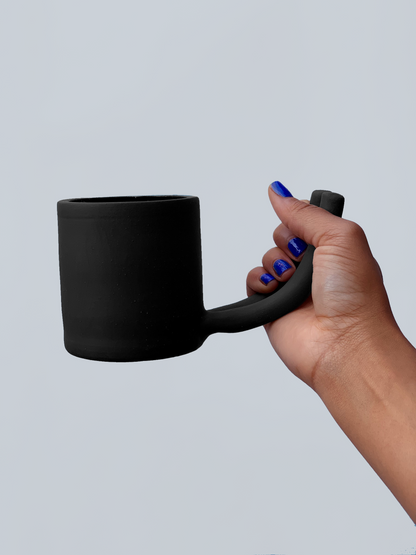 Black matte stoneware ceramic mug with a double prong handle.