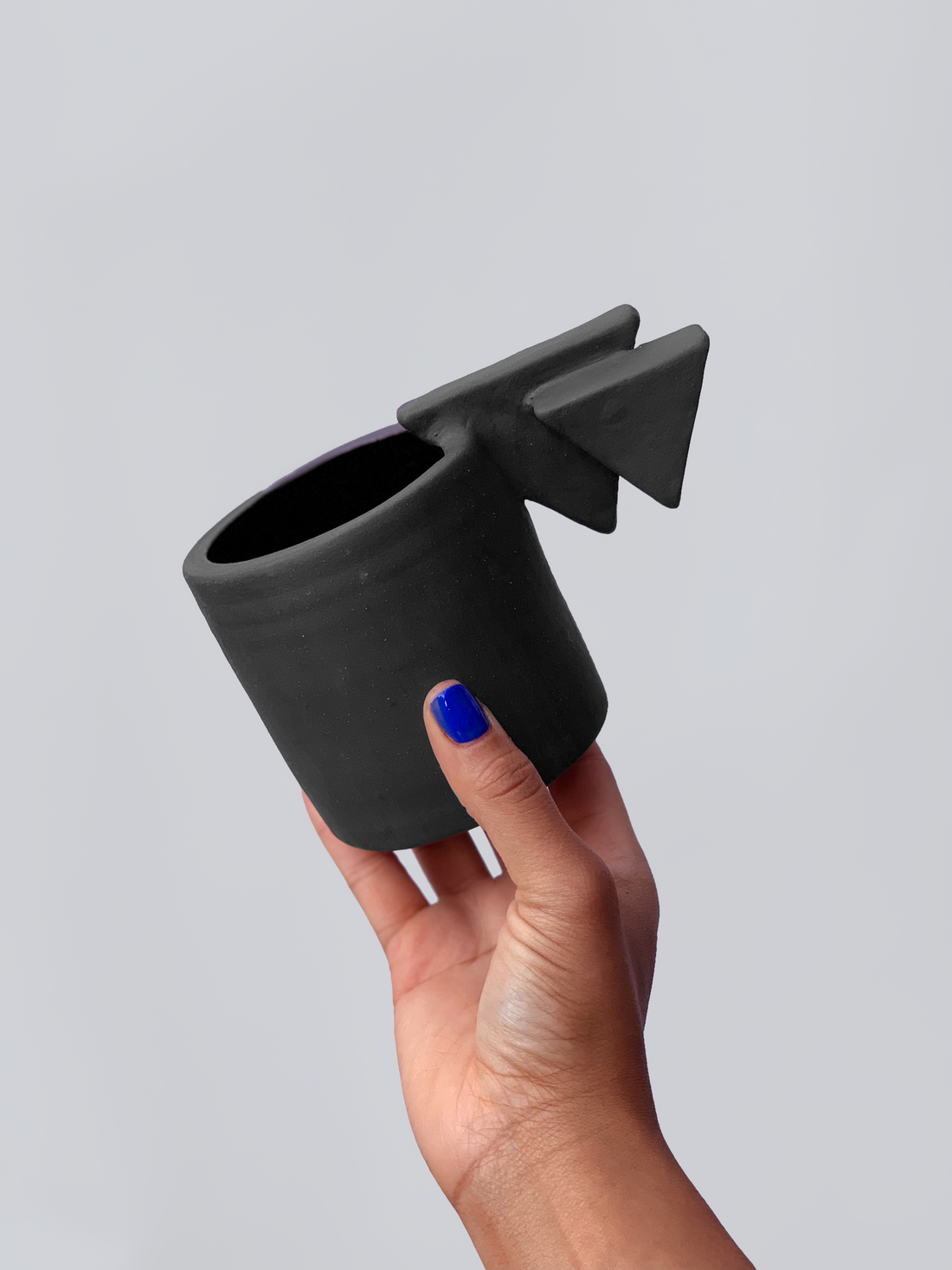Black matte stoneware ceramic mug with a double layered triangle handle.