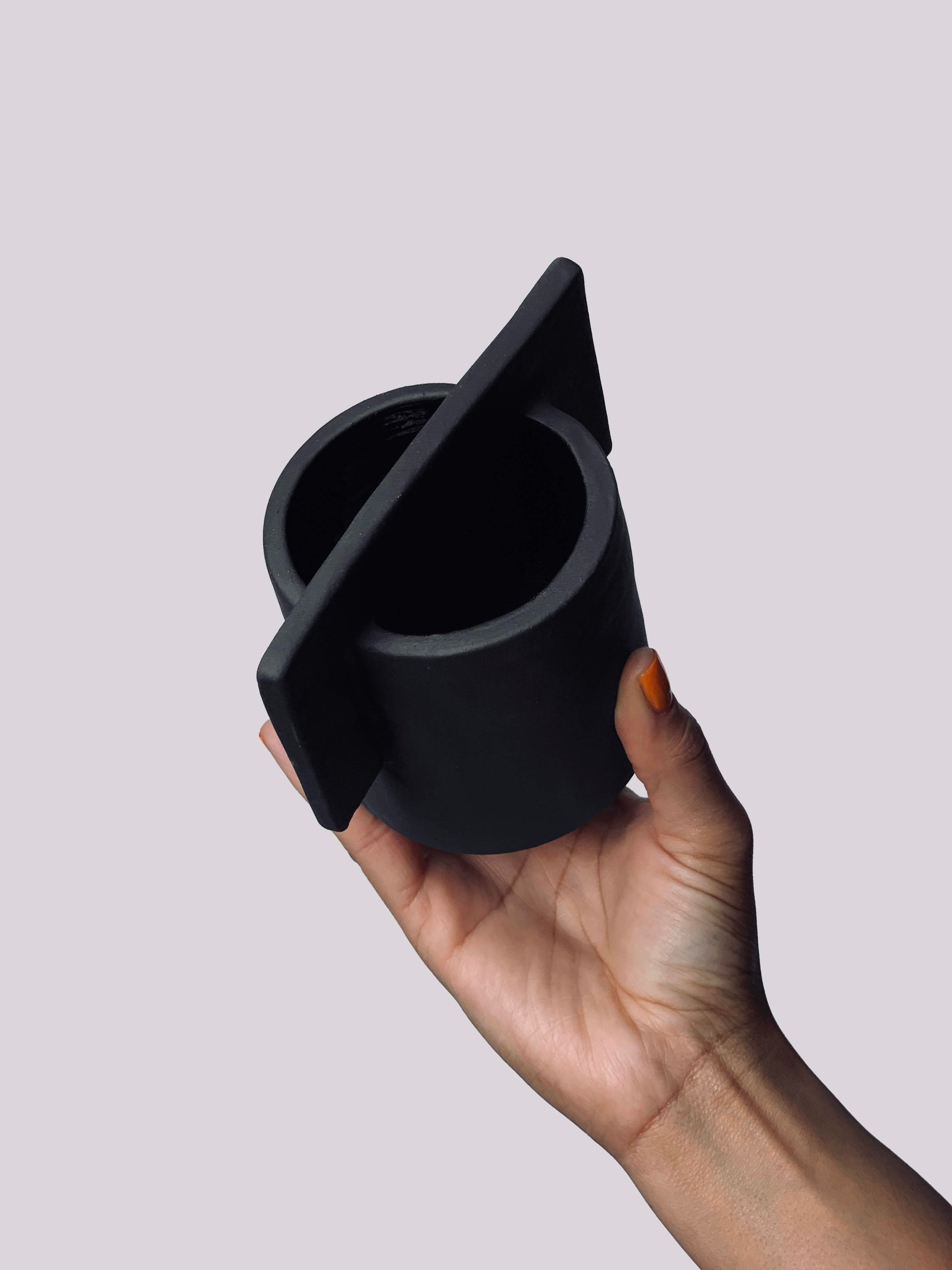 Black matte stoneware ceramic mug with a  flat  center sheet handle.