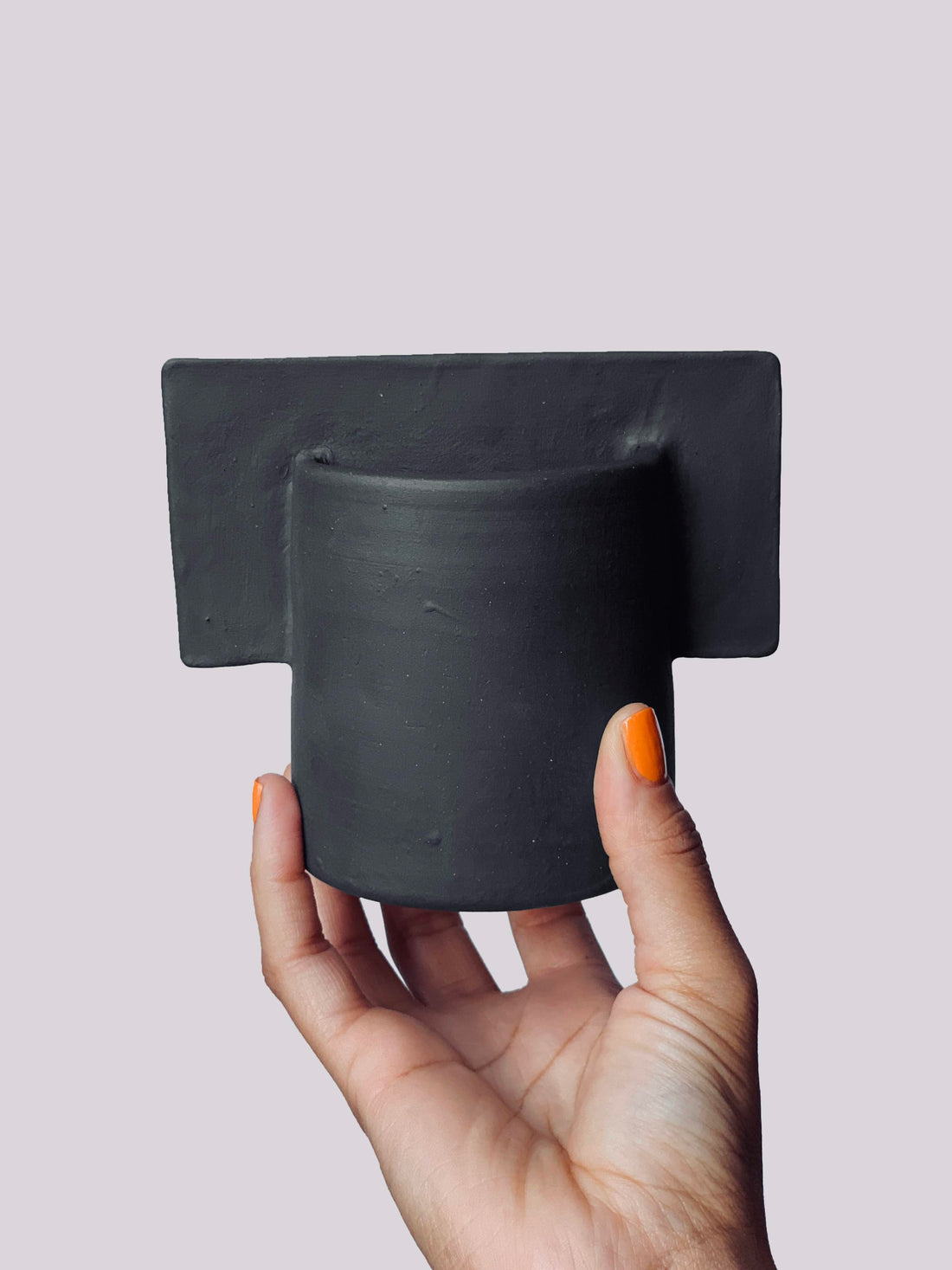 Black matte stoneware ceramic mug with a flat center sheet handle.