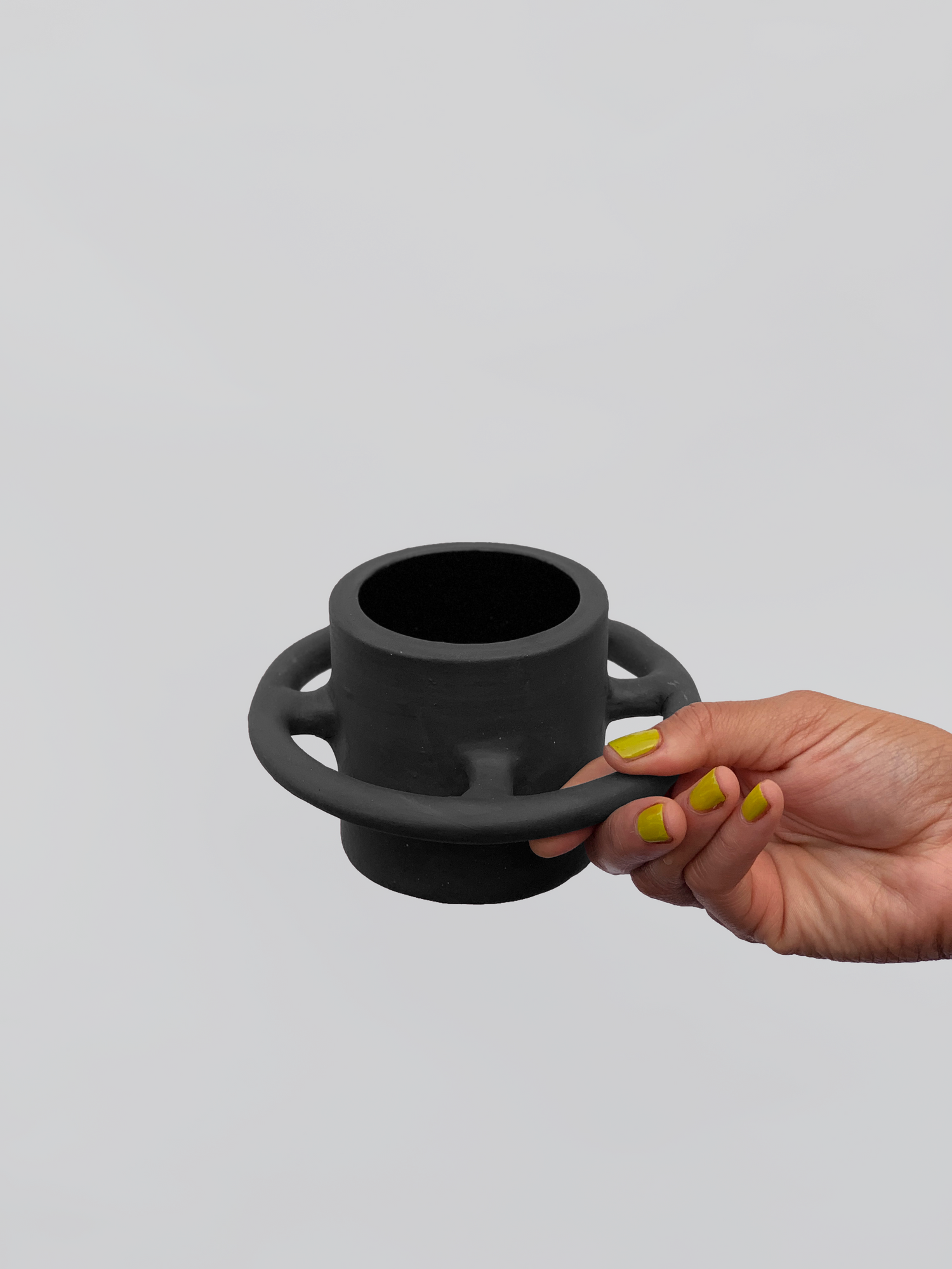Black matte stoneware ceramic mug with full wrap around circle handle.