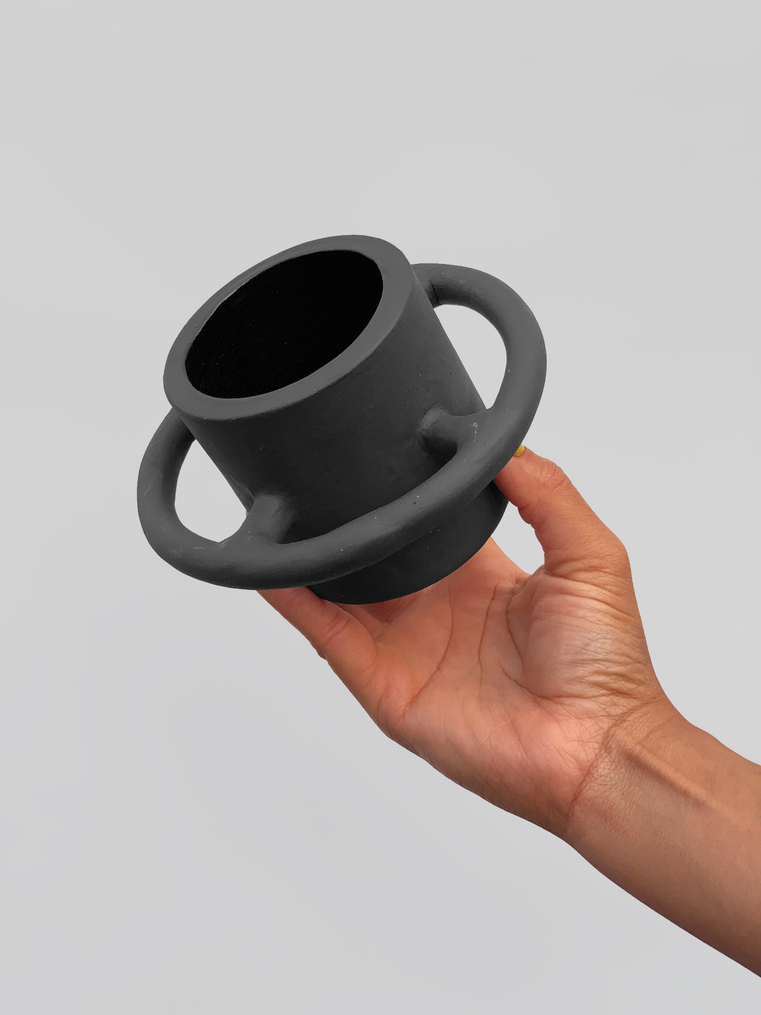 Black matte stoneware ceramic mug with full wrap around circle handle. 