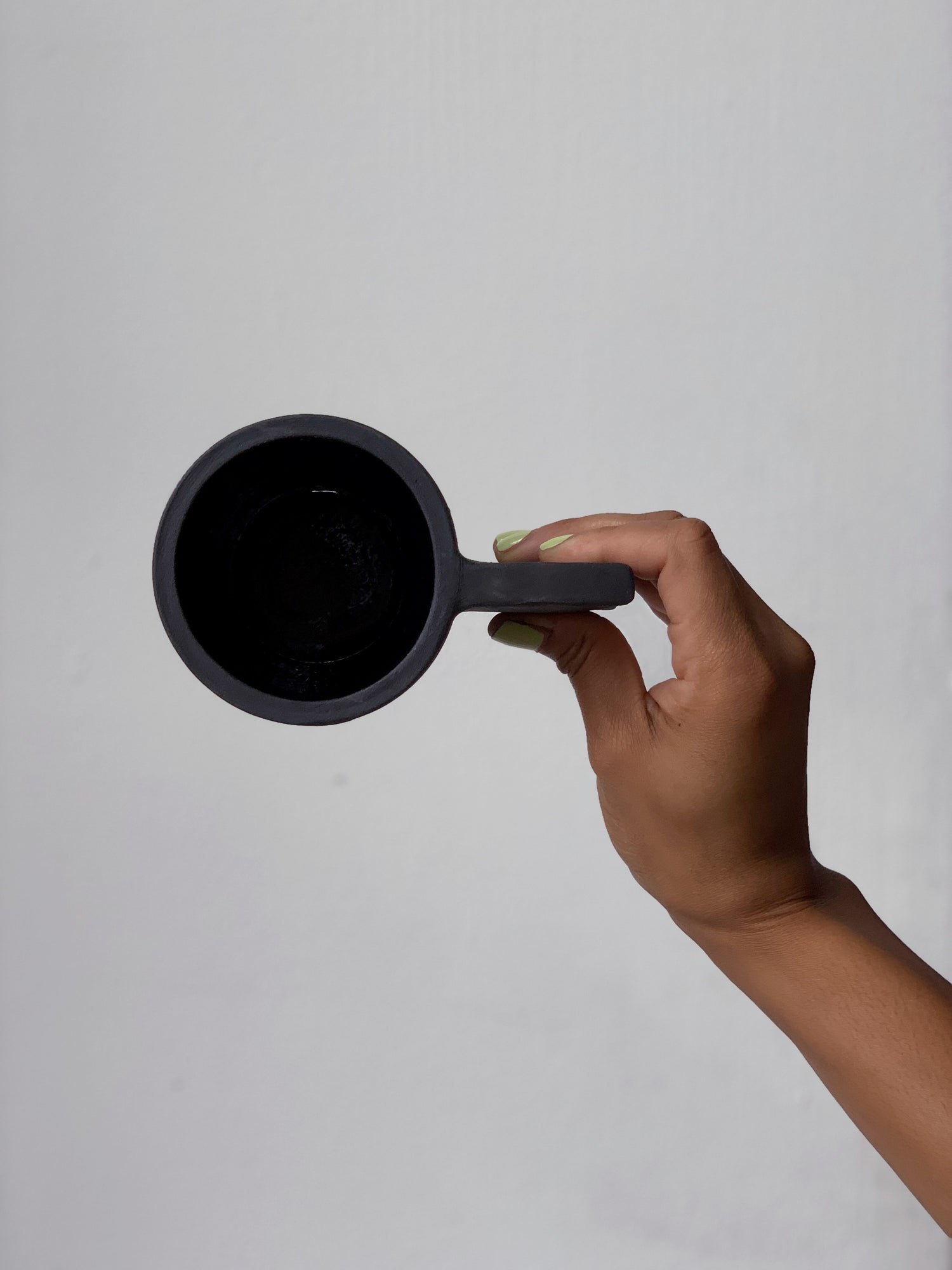 Black matte stoneware ceramic mug with a long flat wide handle.