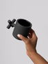 Black matte stoneware ceramic mug with an extended x-shaped side handle.