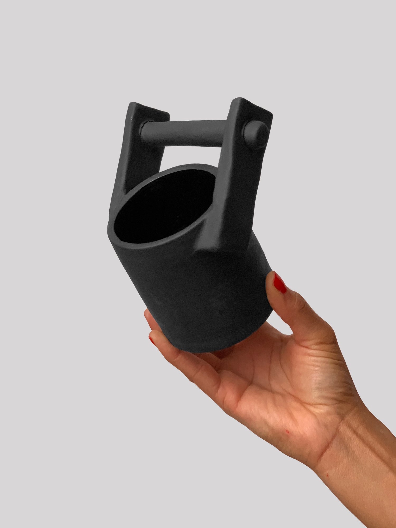 Black matte stoneware ceramic mug with upwards facing bar holder handle.
