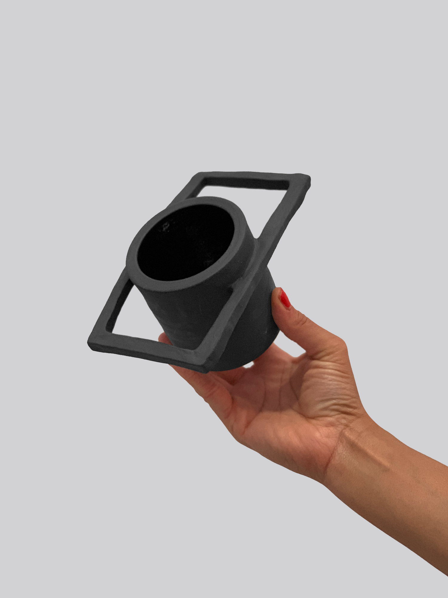 Black matte stoneware ceramic mug with a rectangle frame around the top of the mug as the handle.