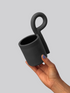 Black matte stoneware ceramic mug with a  tear drop shaped coil on the side of the mug as the handle.