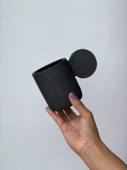 Black matte stoneware ceramic mug with an extended flat full circle handle.