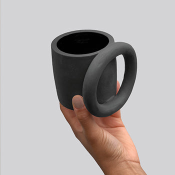 Black matte ceramic mug with a thick full circle ring as the handle.