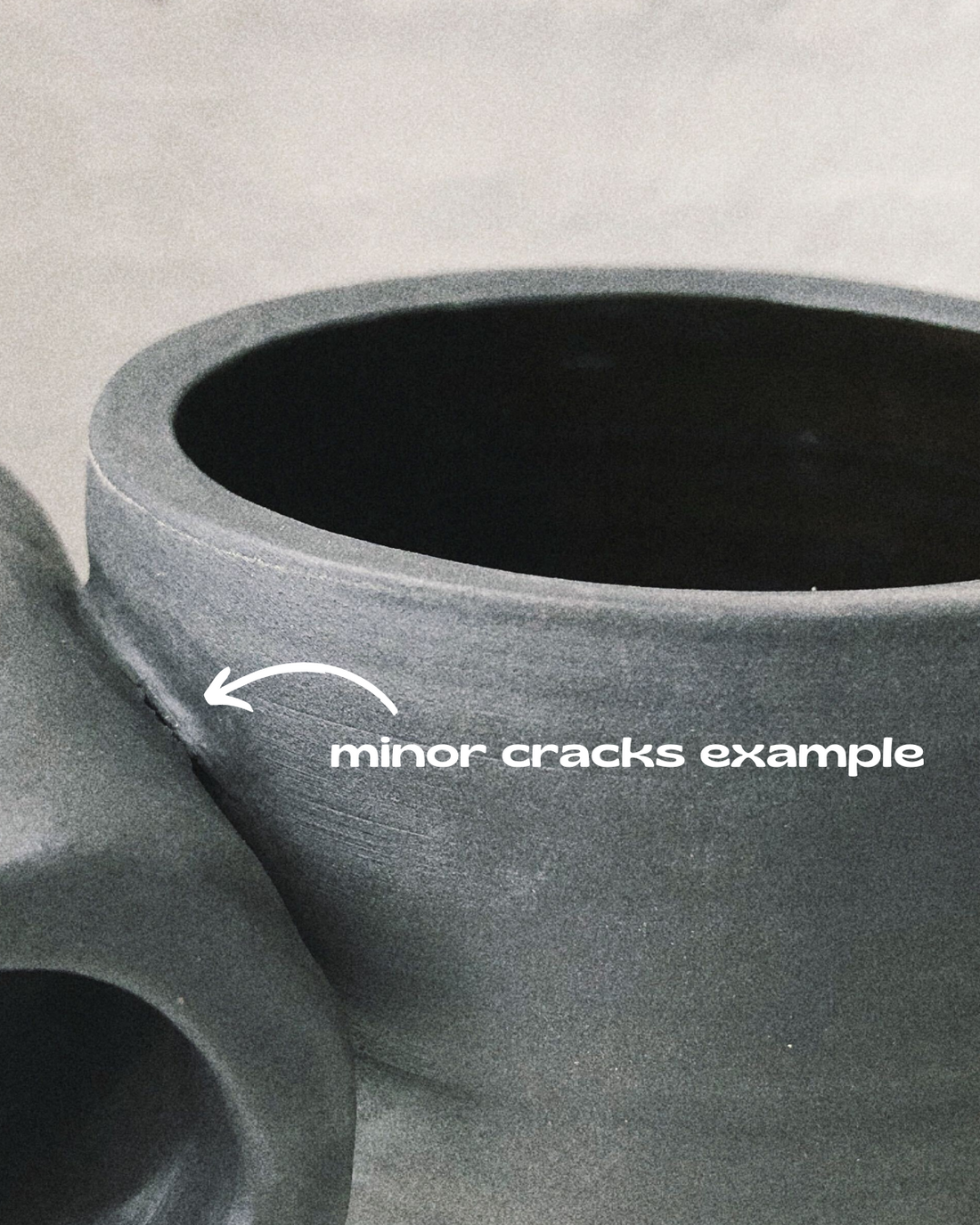 Black matte stoneware ceramic mug with a full side roll as the handle.